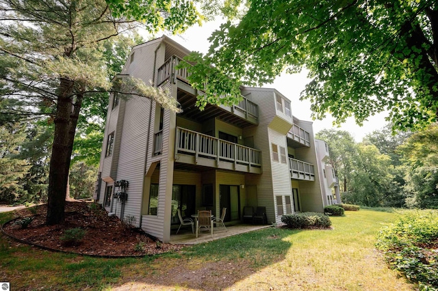 back of house featuring a yard and a patio