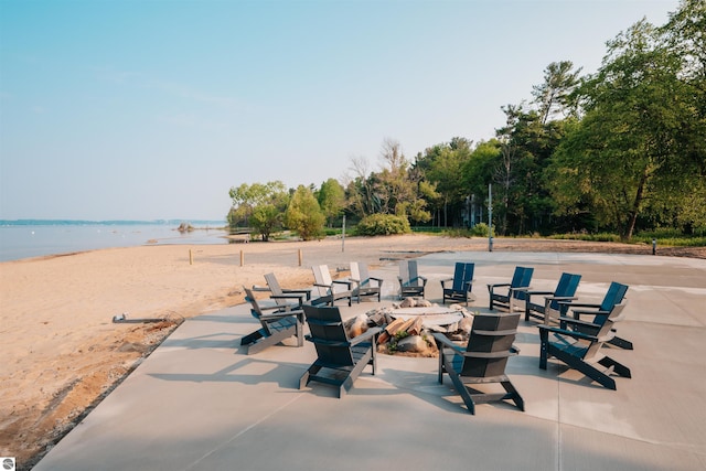 view of patio featuring a view of the beach and a water view