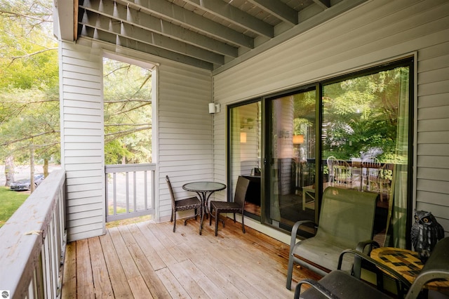 sunroom / solarium featuring wooden ceiling, a wealth of natural light, and beam ceiling