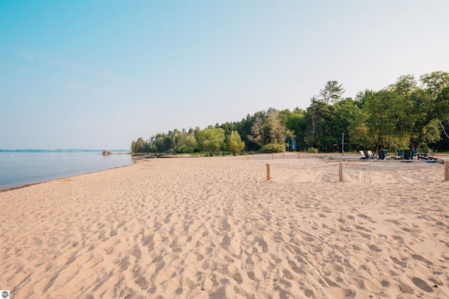 view of community featuring a beach view and a water view