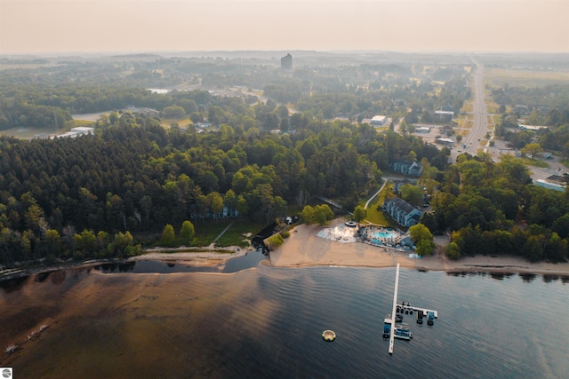 aerial view at dusk featuring a water view