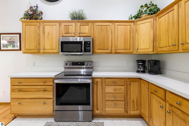 kitchen with stainless steel appliances and wooden walls