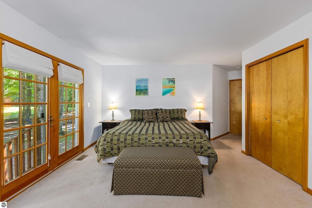 bedroom featuring light carpet and a closet