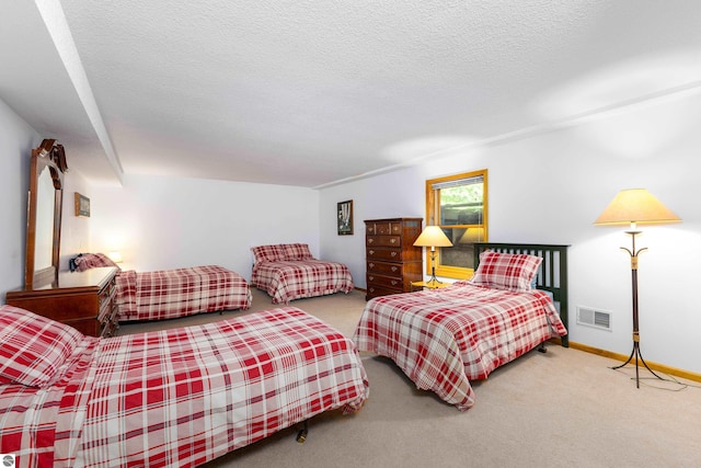 carpeted bedroom featuring a textured ceiling