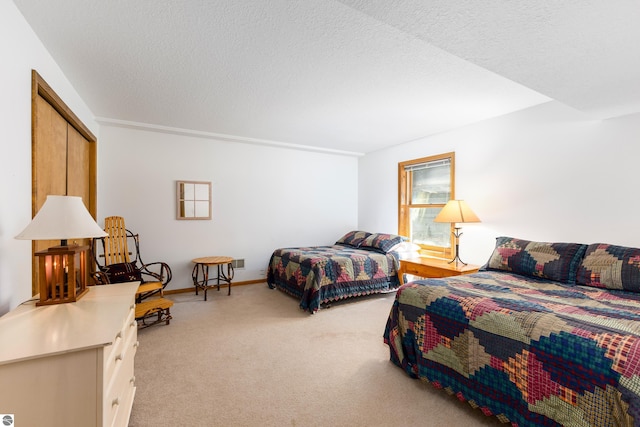 carpeted bedroom featuring a closet and a textured ceiling