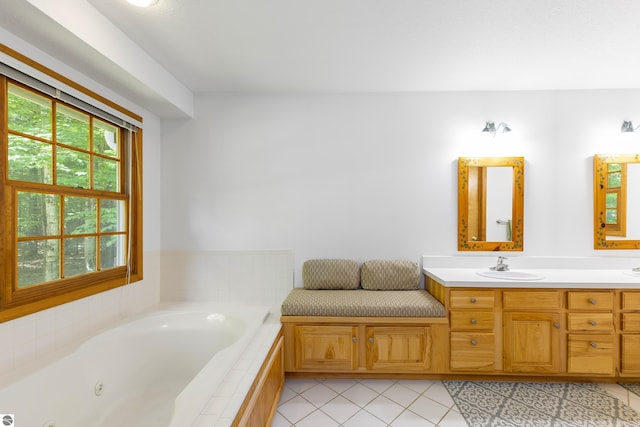 bathroom with vanity, tiled bath, and tile patterned floors