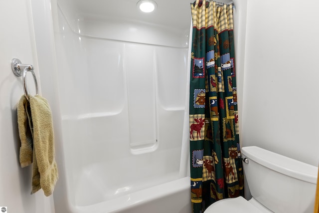 bathroom with shower / bath combination with curtain and toilet