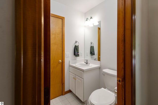 bathroom with vanity, toilet, and tile patterned flooring