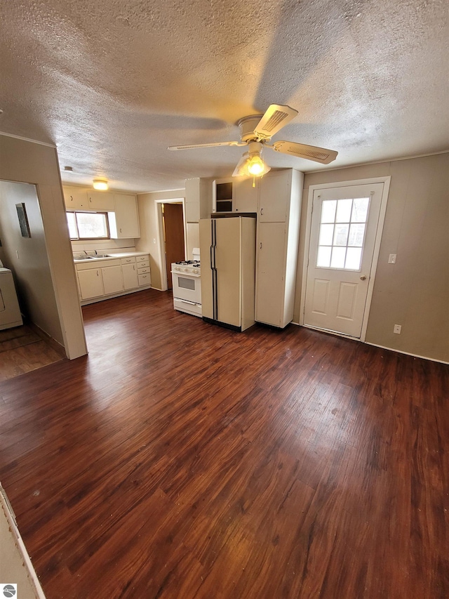 unfurnished living room featuring a textured ceiling, ceiling fan, and dark hardwood / wood-style flooring