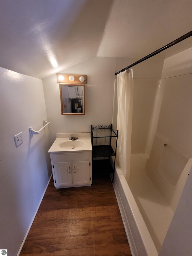 bathroom with lofted ceiling, vanity, shower / bath combo, and hardwood / wood-style flooring