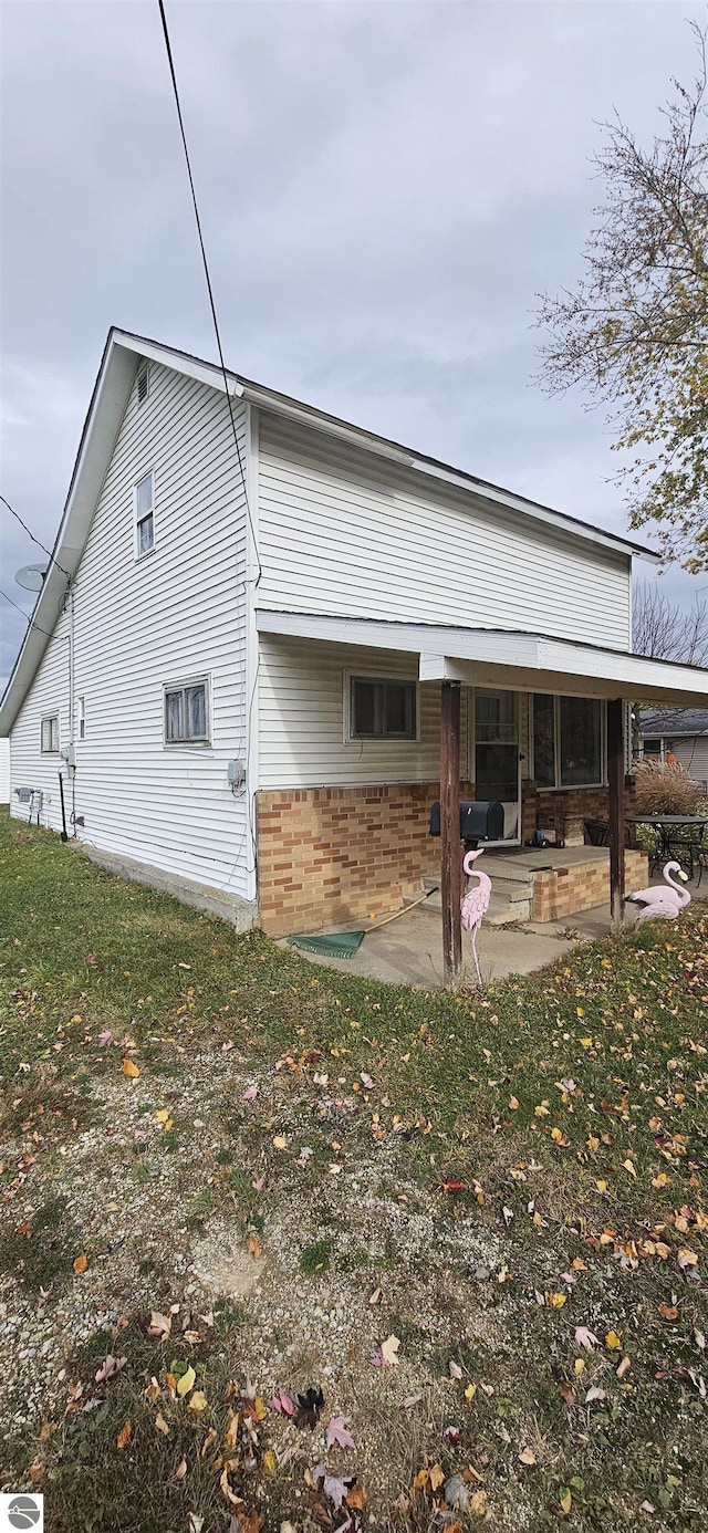 back of house featuring a yard and a patio area