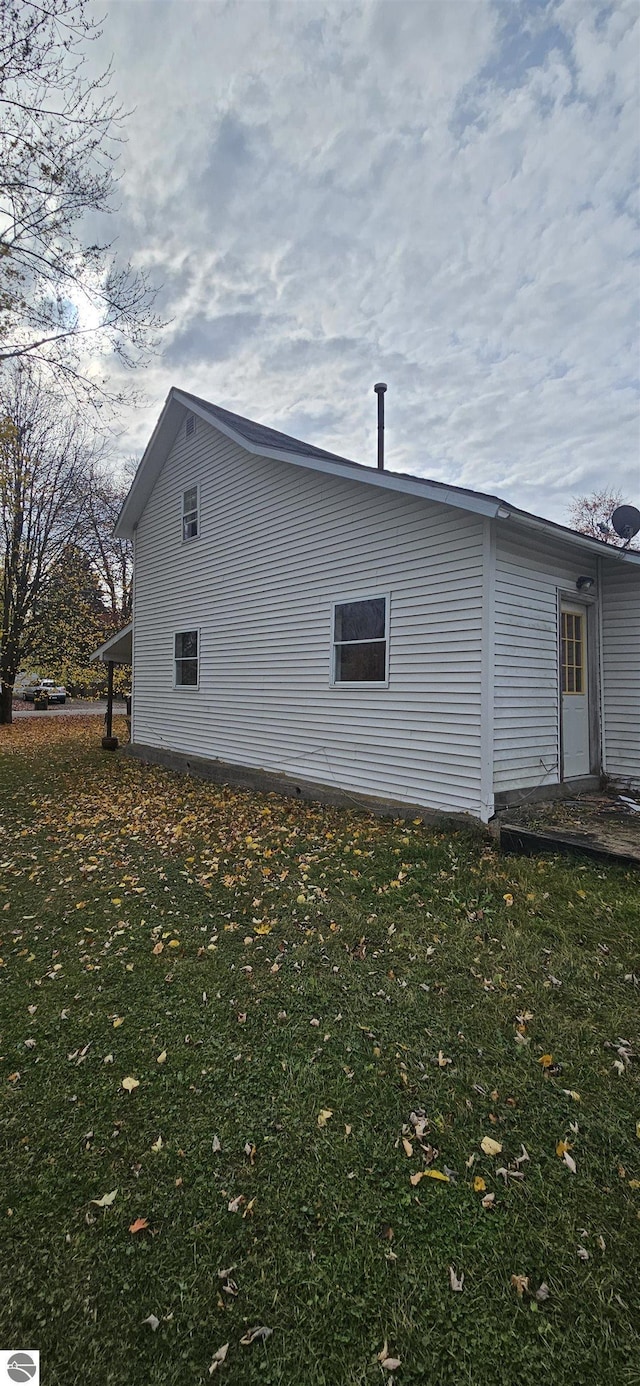 view of side of property with a yard