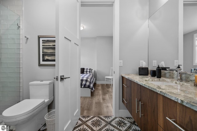 bathroom featuring hardwood / wood-style flooring, vanity, and toilet