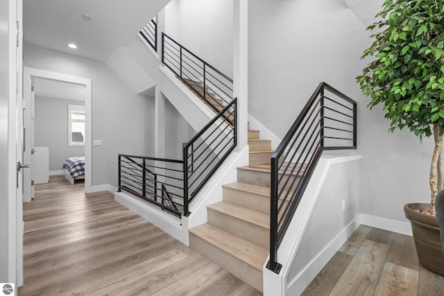 staircase featuring wood-type flooring