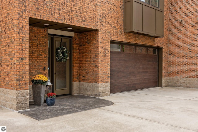 doorway to property with a garage