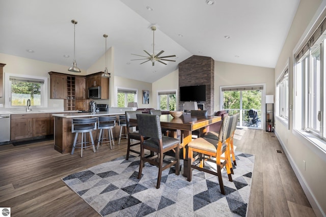 dining area featuring plenty of natural light, dark wood-type flooring, ceiling fan, and sink