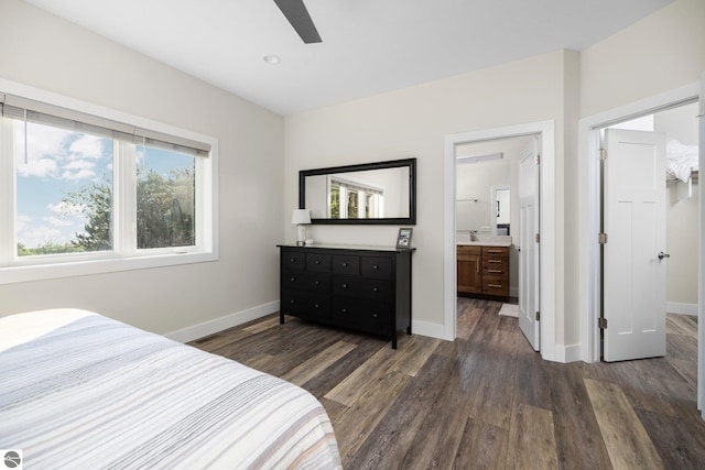 bedroom with ensuite bath, ceiling fan, and dark hardwood / wood-style flooring