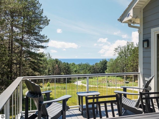 balcony featuring a deck with water view