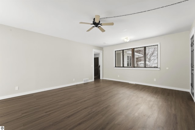 spare room with ceiling fan and dark hardwood / wood-style floors