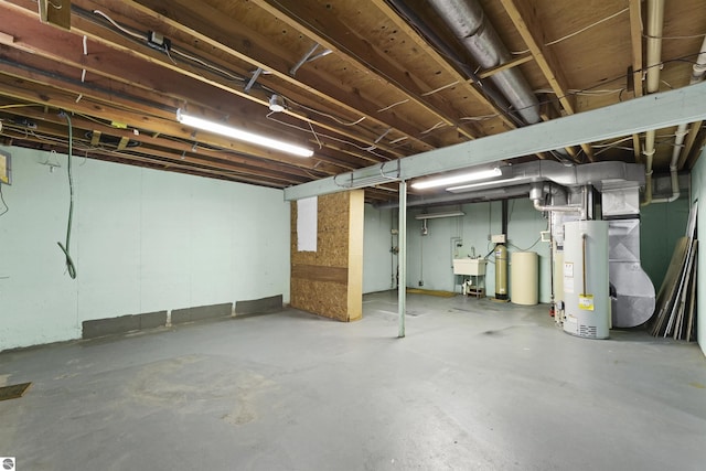 basement featuring gas water heater and sink