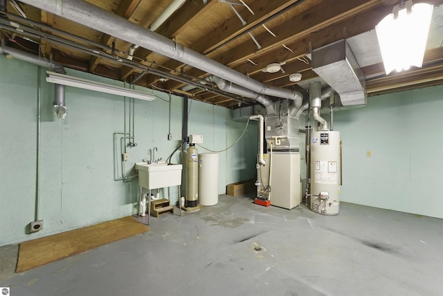 basement with sink, heating unit, and water heater