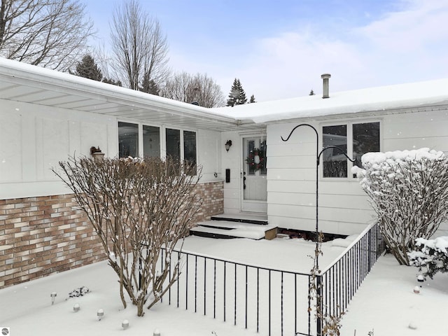 view of snow covered property entrance