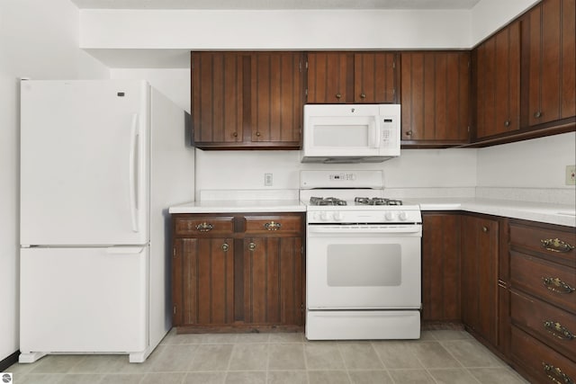 kitchen with white appliances and dark brown cabinetry