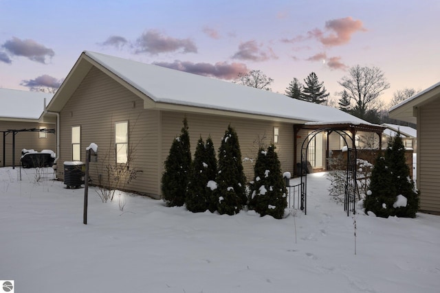 snow covered property featuring central air condition unit