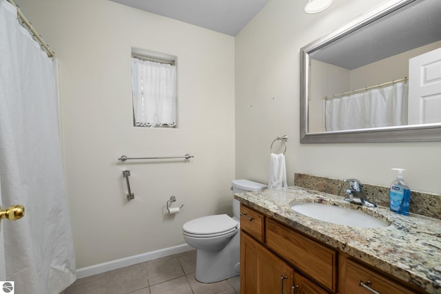 bathroom with toilet, tile patterned flooring, and vanity