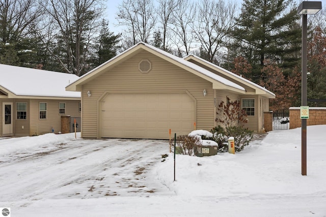 view of snowy exterior with a garage