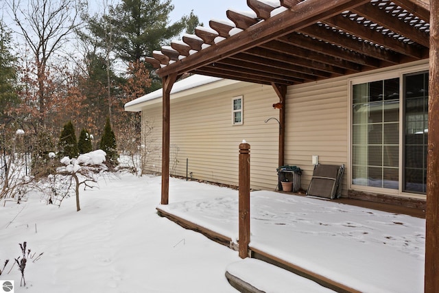 snow covered deck with a pergola