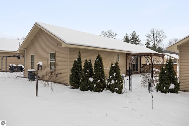 view of snow covered exterior featuring a gazebo and cooling unit