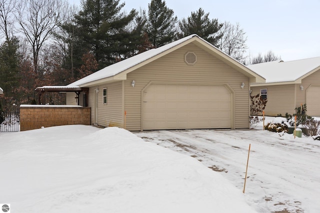 exterior space featuring a garage and an outbuilding