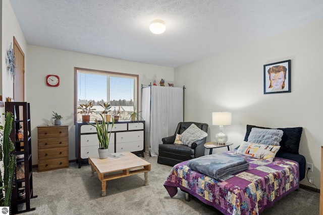 carpeted bedroom featuring a textured ceiling