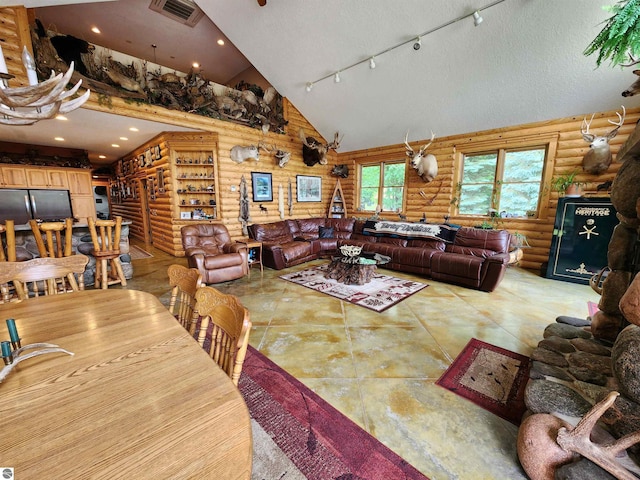 dining room with a textured ceiling, track lighting, log walls, and high vaulted ceiling