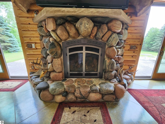 interior details with a fireplace and rustic walls