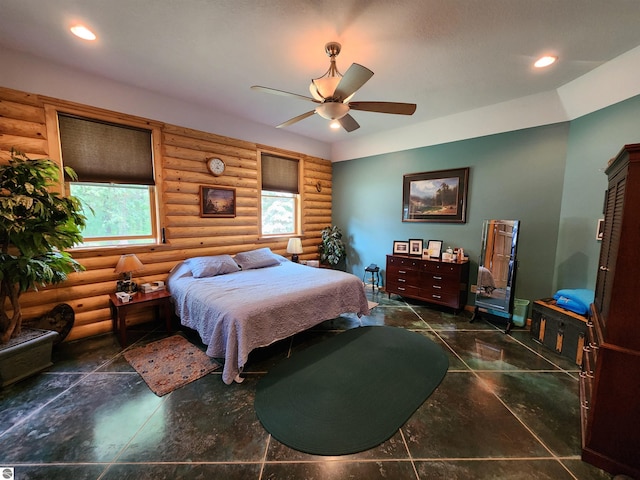 bedroom featuring rustic walls and ceiling fan