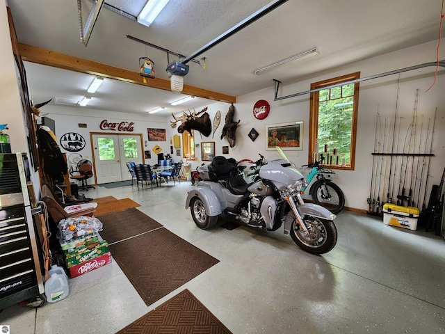 garage with a garage door opener and french doors