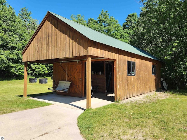 view of outbuilding with a lawn