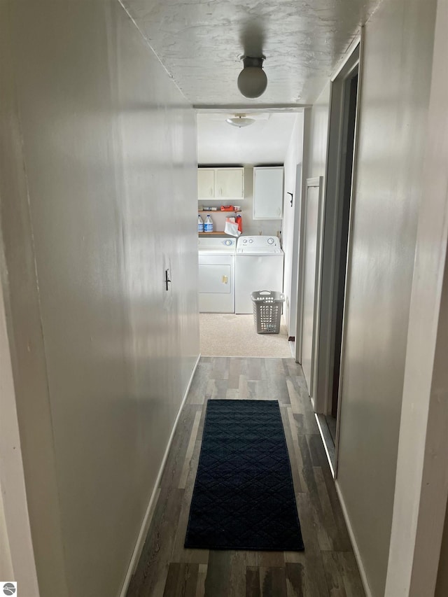 hall with washing machine and clothes dryer and hardwood / wood-style flooring