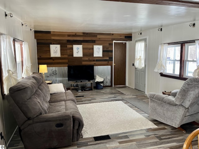 living room with wooden walls and wood-type flooring