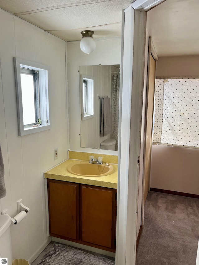 bathroom featuring toilet and vanity