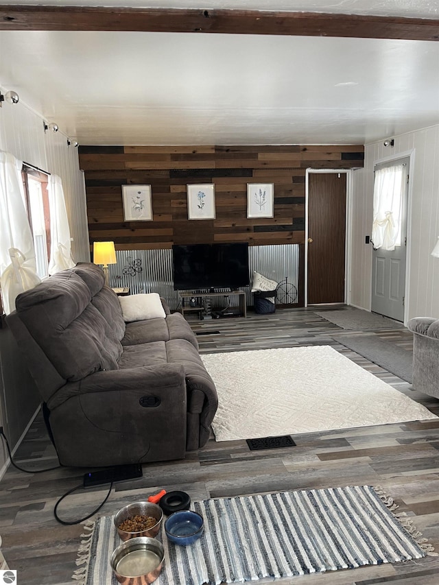 living room featuring hardwood / wood-style floors and wooden walls