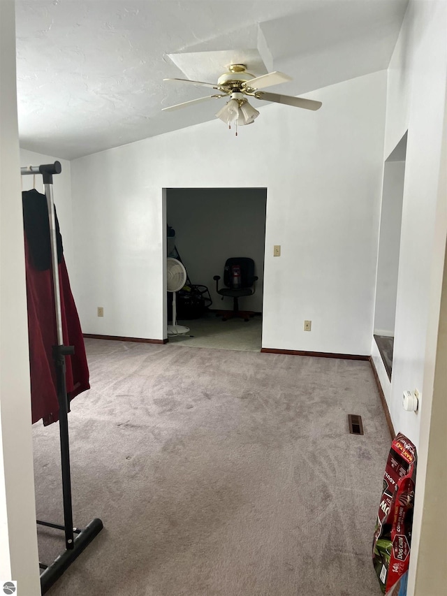 empty room featuring carpet floors and ceiling fan