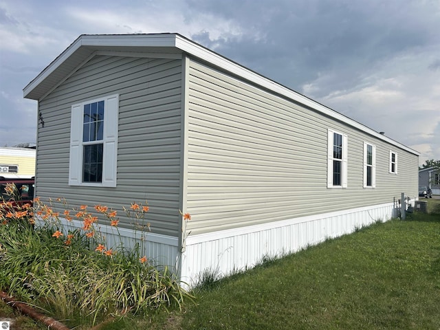 view of home's exterior with a lawn