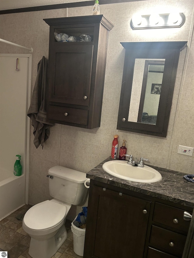 bathroom featuring toilet and vanity