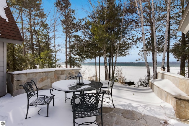 view of patio featuring a beach view and a water view