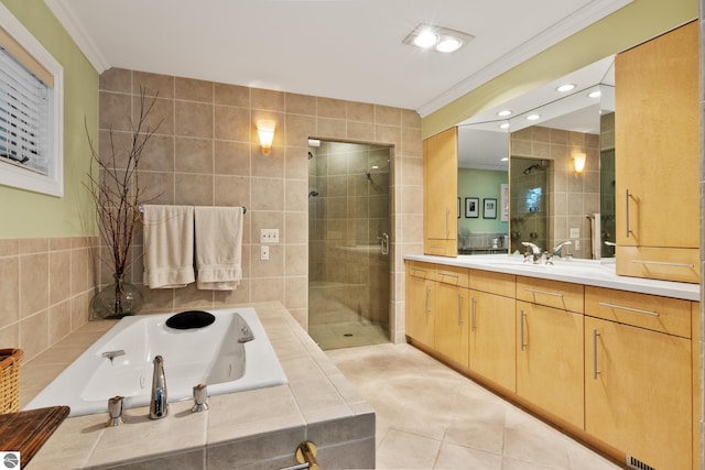 bathroom with tile patterned flooring, vanity, ornamental molding, tile walls, and separate shower and tub