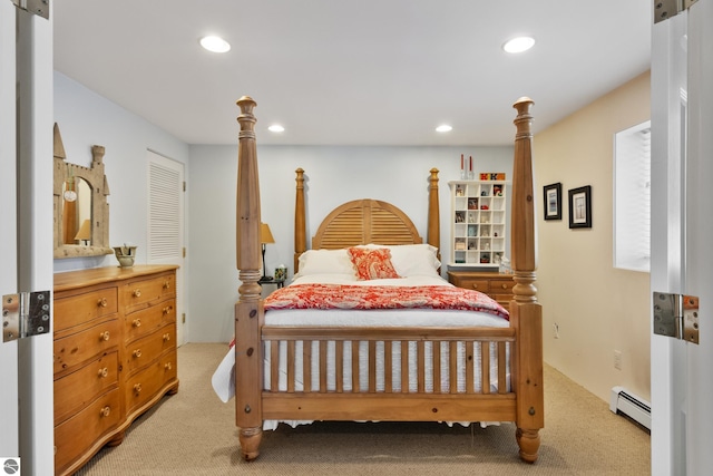 bedroom with a baseboard radiator and light carpet