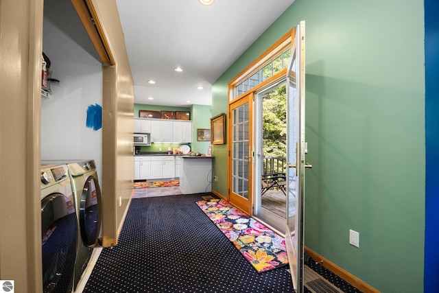 entryway featuring washing machine and clothes dryer and carpet flooring